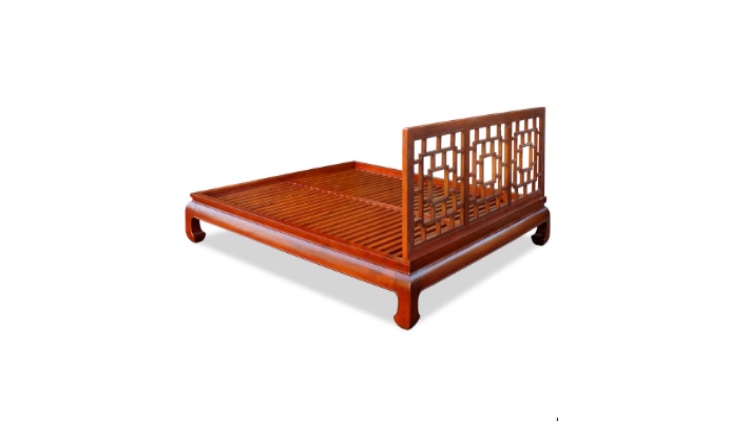a wooden Chinese platform bed with intricate patterns